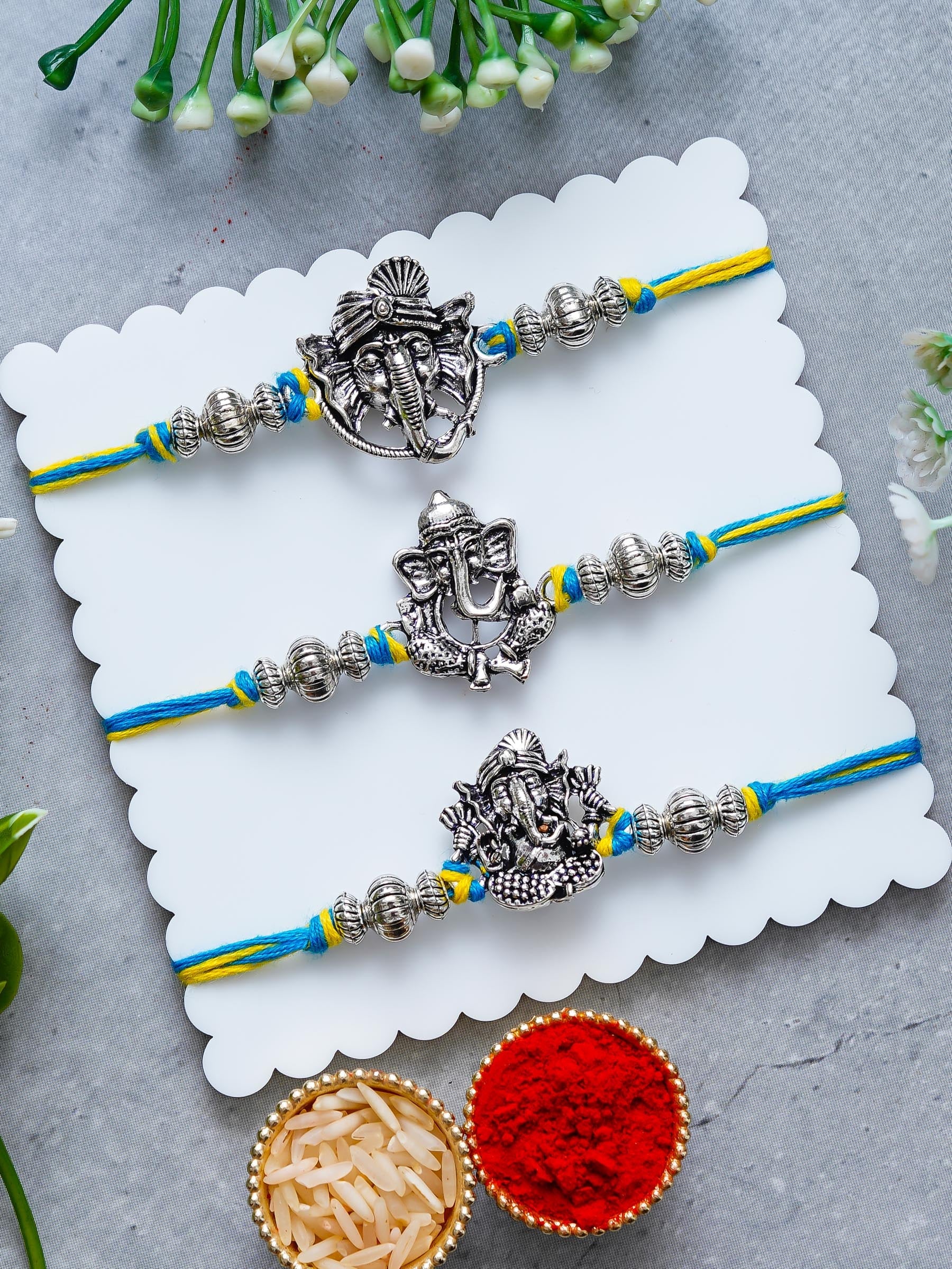 Lord Ganesha Rakhi Set of 3 – Antique Metal Finish – Free Chawal & Kumkum